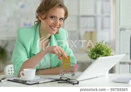 Woman working on laptop 99788865