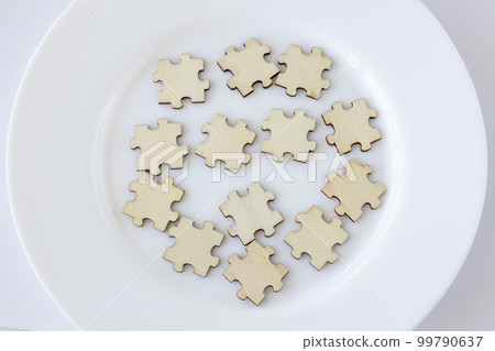 Mock up of 13 wooden puzzles on a plate. Thirteen blank spaces for inscription. The concept of healthy eating 99790637