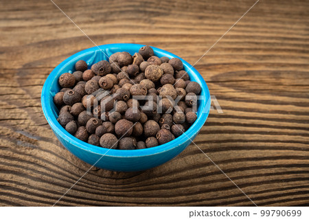 Allspice spice in a small bowl on the table Allspice spice in a small bowl on the table 99790699