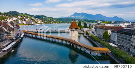Famous Chapel Bridge over River Reuss in Lucerne Famous Chapel Bridge over River Reuss in Lucerne 99790710
