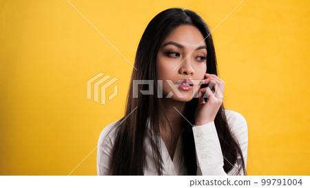 Thoughtful young woman against a neutral background 99791004