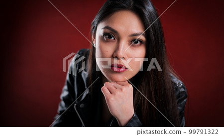 Young self-confident woman against a red background 99791322