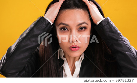 Young woman in her mid-20s posing for the camera Young woman in her mid-20s posing for the camera 99791327