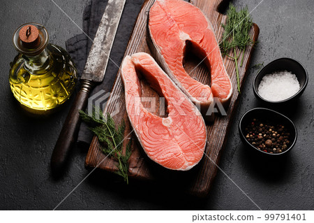 Fresh raw salmon steak. Two fish steaks and spices Fresh raw salmon steak. Two fish steaks and spices 99791401