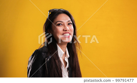 Young happy woman laughs into the camera Young happy woman laughs into the camera 99791477
