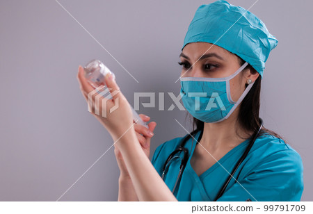 Doctor prepares syringe for vaccination Doctor prepares syringe for vaccination 99791709