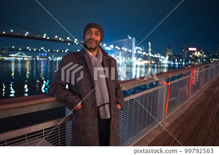 Afro American Man at Brooklyn Bridge by night - travel photography Afro American Man at Brooklyn Bridge by night - travel photography 99792563