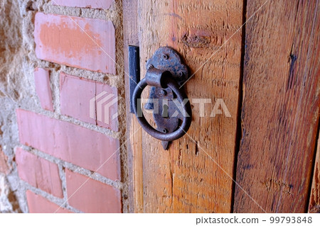 Old wooden door with metal ring handle Old wooden door with metal ring handle 99793848