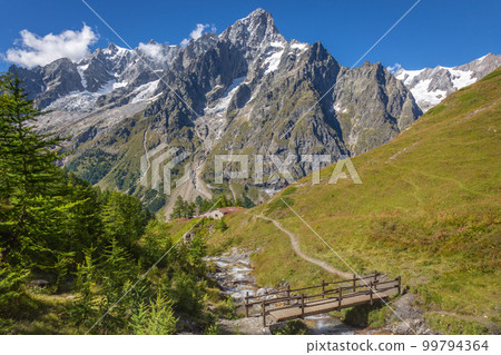Landscape of Aosta valley near Mont Blanc massif with river and bridge, Italy 99794364