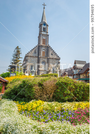 Stone Church with colorful flowerbed, Gramado village, Southern Brazil 99794695