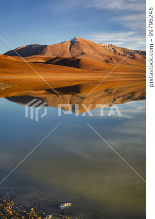 Salt lake Lejia reflection, idyllic volcanic landscape at Sunset, Atacama, Chile 99796248