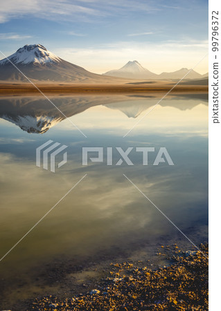 Salt lake Lejia reflection, idyllic volcanic landscape at Sunset, Atacama, Chile Salt lake Lejia reflection, idyllic volcanic landscape at Sunset, Atacama, Chile 99796372