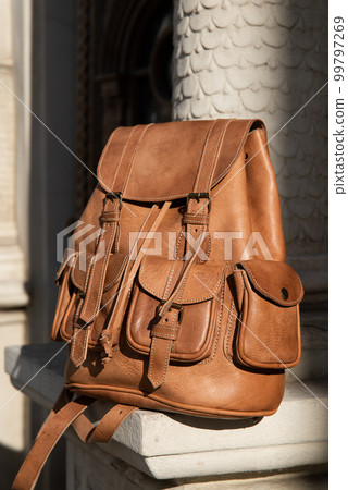 photo of a light brown, retro look leather backpack photo of a light brown, retro look leather backpack 99797269