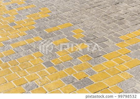 Yellow and grey paving tile floor mosaic urban texture street road background Yellow and grey paving tile floor mosaic urban texture street road background 99798532
