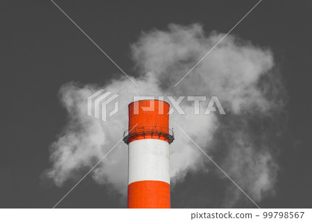 Pollution of the environment, ecology and air. Withdrawal of combustion products of soot, smoke and gases from the pipe of an industrial plant into the atmosphere against the background of a gray sky 99798567