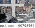 A view from an apartment in NY, a laptop and cushions 99798569