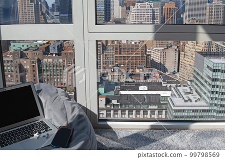 A view from an apartment in NY, a laptop and cushions A view from an apartment in NY, a laptop and cushions 99798569