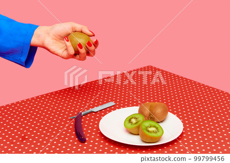 Plate with delicious kiwi and razor on red vintage tablecloth against pink studio background. Food pop art photography. 99799456