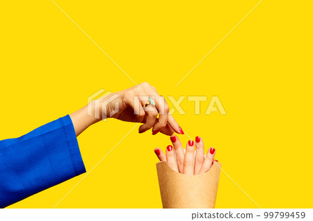 Female fingers instead of fries into packaging against yellow studio background. Surrealism and creativity. Food pop art photography. Fast food Female fingers instead of fries into packaging against yellow studio background. Surrealism and creativity. Food pop art photography. Fast food 99799459