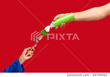 Female hand holding broccoli on fork with whipped cream against red studio background. Healthy eating. Food pop art photography. Female hand holding broccoli on fork with whipped cream against red studio background. Healthy eating. Food pop art photography. 99799462