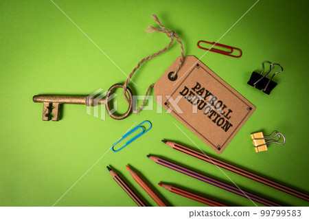 Payroll Deduction. Golden key with price tag on green office table Payroll Deduction. Golden key with price tag on green office table 99799583