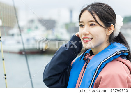 Cute woman enjoying fishing Cute woman enjoying fishing 99799730