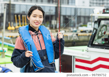 Cute woman enjoying fishing 99799732