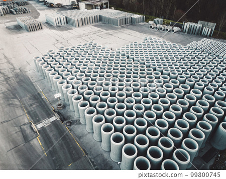 Huge concrete pipes stacked in lines, aerial view 99800745