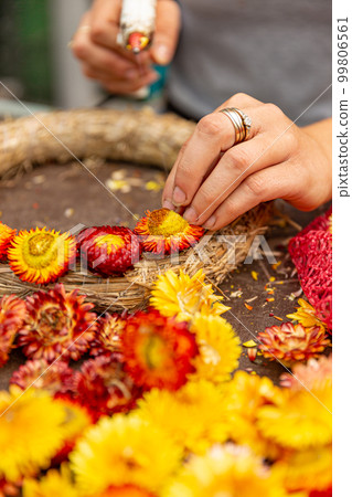 Woman hands makes an autumn wreath Woman hands makes an autumn wreath 99806561