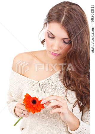 Woman tearing flower petal Woman tearing flower petal 99808012