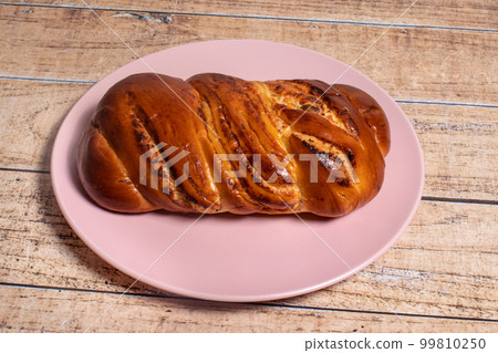 Tasty fragrant wicker bun for breakfast. Bread made from wheat flour with curd filling for the whole family. Tasty fragrant wicker bun for breakfast. Bread made from wheat flour with curd filling for the whole family. 99810250