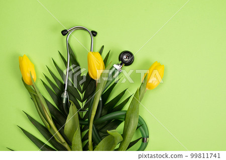 Bouquet of flowers and stethoscope on a green background, a place for text, happy doctors day, nurses week and other medical holidays. Bouquet of flowers and stethoscope on a green background, a place for text, happy doctors day, nurses week and other medical holidays. 99811741