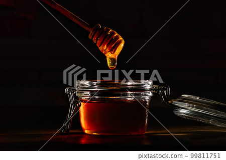 Honey with a natural wooden stick Honey with a natural wooden stick 99811751
