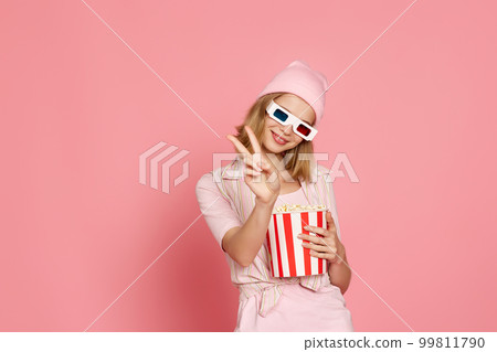 pretty blonde girl holding bucket of popcorn pretty blonde girl holding bucket of popcorn 99811790