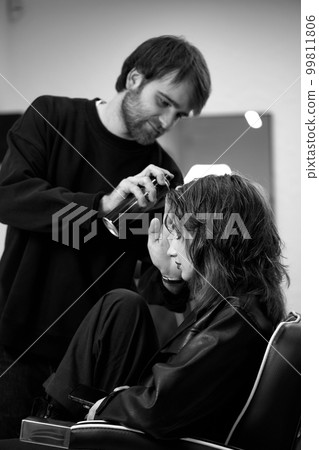 male hairdresser fixing hair of young woman with hairspray. male hairdresser fixing hair of young woman with hairspray. 99811806