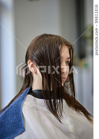 young girl gets fashionable haircut in modern salon 99811816