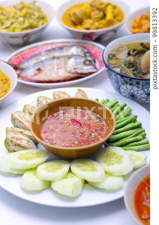 Shrimp Paste Chilli Sauce (Nam Prik Ka Pi) serve with fresh cucumber, fresh green brinjals, and fresh long beans, Thai food on isolated background. Shrimp Paste Chilli Sauce (Nam Prik Ka Pi) serve with fresh cucumber, fresh green brinjals, and fresh long beans, Thai food on isolated background. 99813392
