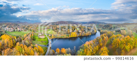 Fojtka water reservoir surrounded by vibrant colored forest at autumn time. Aerial view from drone. 99814616