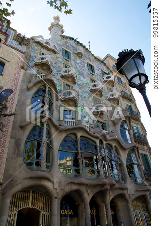 BARCELONA, SPAIN - AUG 30th, 2017: The curving shaped stone facade of Gaudi's Casa Batllo, outdoor view on a sunny day BARCELONA, SPAIN - AUG 30th, 2017: The curving shaped stone facade of Gaudi's Casa Batllo, outdoor view on a sunny day 99815557