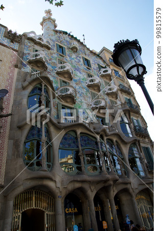 BARCELONA, SPAIN - AUG 30th, 2017: The curving shaped stone facade of Gaudi's Casa Batllo, outdoor view on a sunny day BARCELONA, SPAIN - AUG 30th, 2017: The curving shaped stone facade of Gaudi's Casa Batllo, outdoor view on a sunny day 99815579