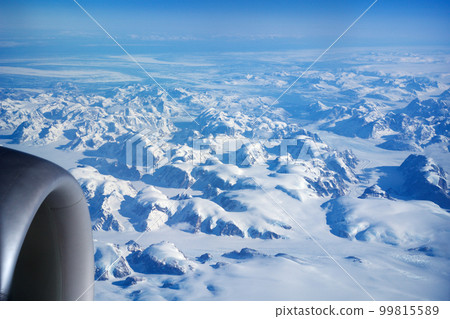 GREENLAND - 10 MAY 2018: View from the aircraft window of the engine of a Boeing 787 over the icebergs of Greenland 99815589