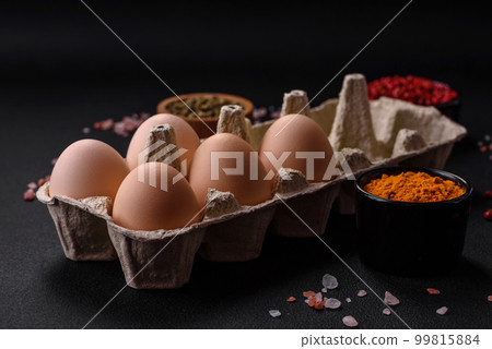 Fresh raw chicken eggs in beige color in a cardboard tray Fresh raw chicken eggs in beige color in a cardboard tray 99815884