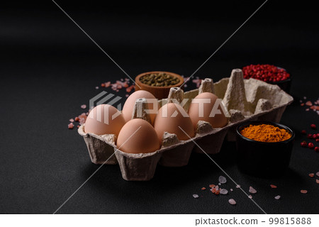 Fresh raw chicken eggs in beige color in a cardboard tray Fresh raw chicken eggs in beige color in a cardboard tray 99815888