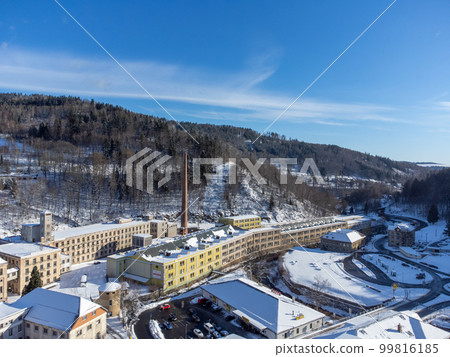Aerial view from a drone of the old factory with a tall chimney on a sunny winter day in the town of Tanvald, Czech Republic Aerial view from a drone of the old factory with a tall chimney on a sunny winter day in the town of Tanvald, Czech Republic 99816185