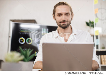 Confident caucasian man in white shirt sitting at modern office and using wireless laptop. Confident caucasian man in white shirt sitting at modern office and using wireless laptop. 99816562
