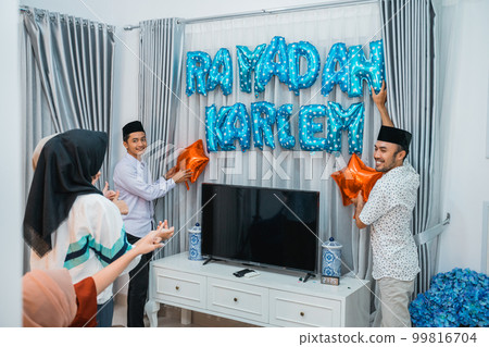 two Muslim men and two women put up decorations 99816704