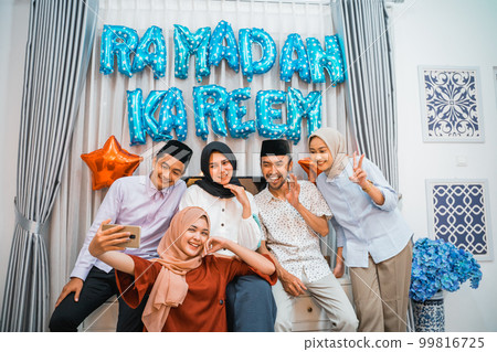 group of Muslim friends take a selfie together while ramadan 99816725