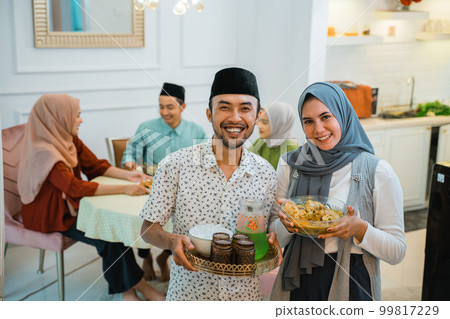 asian couple serving food for friend for break fasting 99817229
