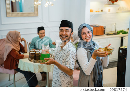 asian couple serving food for family for break fasting 99817274