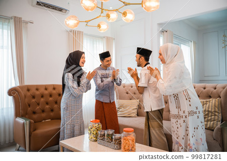 Muslim couples visit neighbors to wish them a happy Eid Muslim couples visit neighbors to wish them a happy Eid 99817281